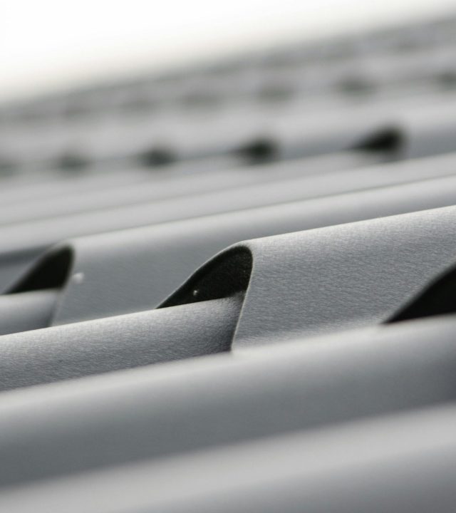 Detailed close-up of grey metal roof sheets showcasing texture and design.